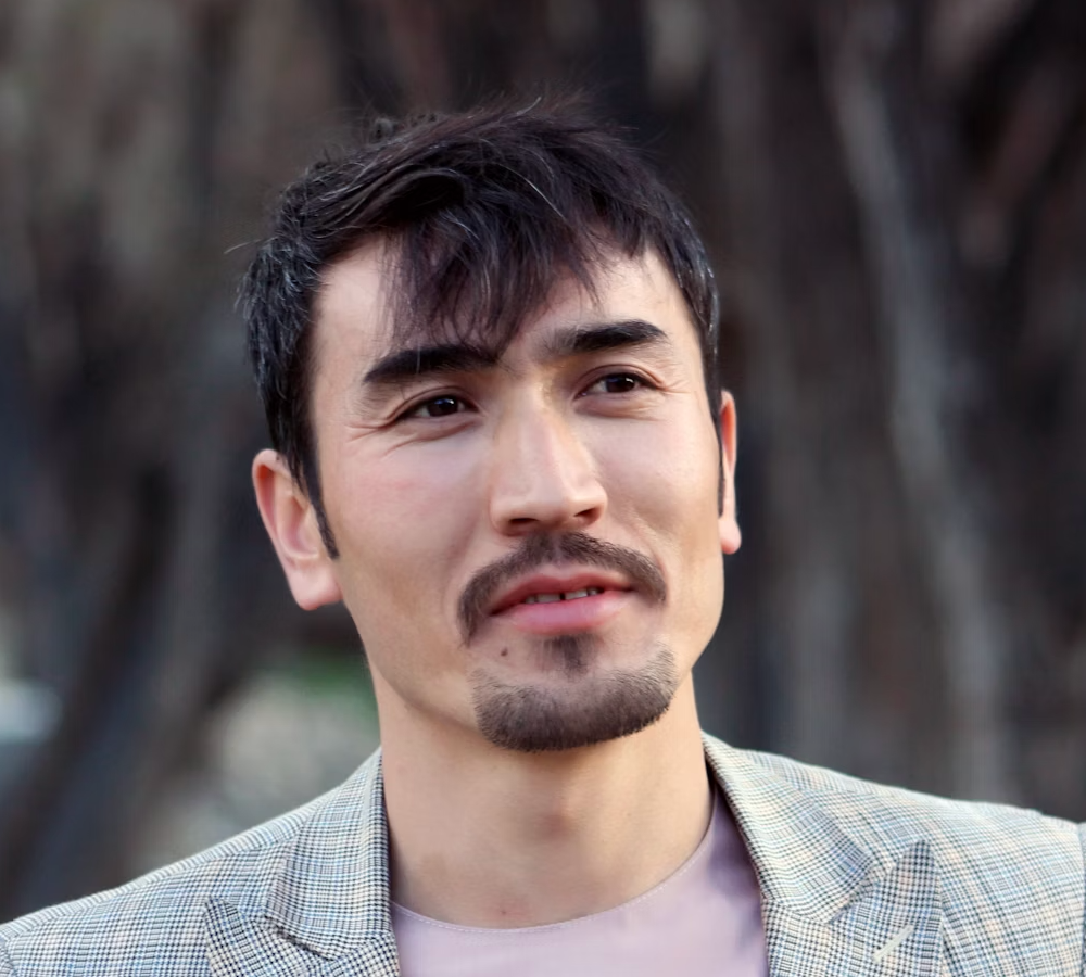 Man in blazer looking into the distance